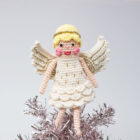 Crocheted angel on top of pick glittery tree