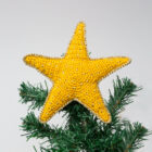 Crocheted star tree topper on a green Christmas tree